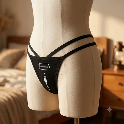 Women's black strappy thong with Please charge battery graphic from side angle