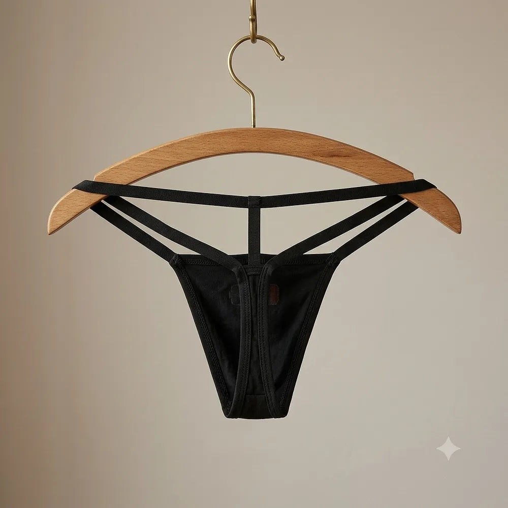 Women's black strappy graphic thong displayed on wooden hanger