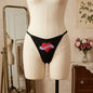 Women's black DADDY thong with red heart graphic from side angle