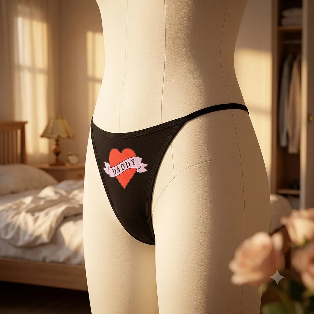Close-up of side strap on black women's thong